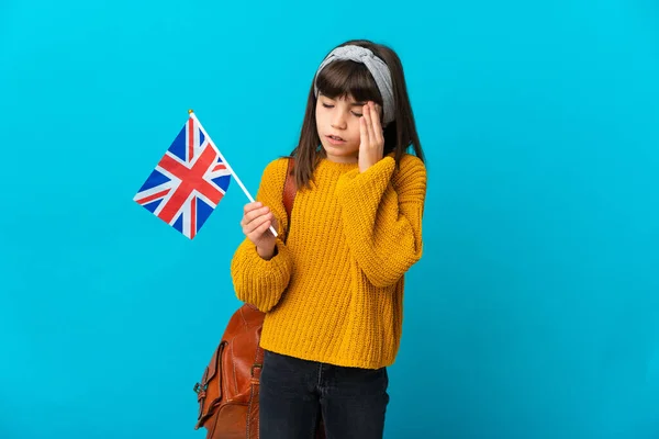 Little girl studying English isolated on blue background with headache