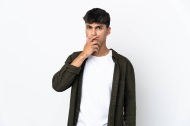 Young man over isolated white background surprised and shocked while looking right