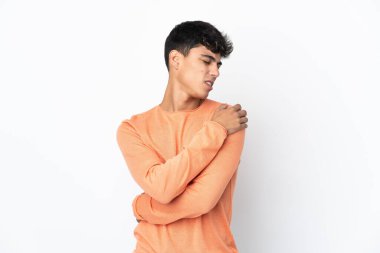 Young man over isolated white background suffering from pain in shoulder for having made an effort