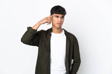 Young man over isolated white background making the gesture of madness putting finger on the head