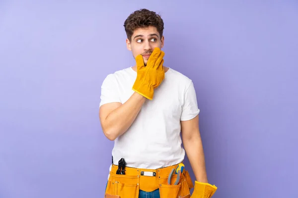 Young electrician man over isolated on purple background thinking an idea