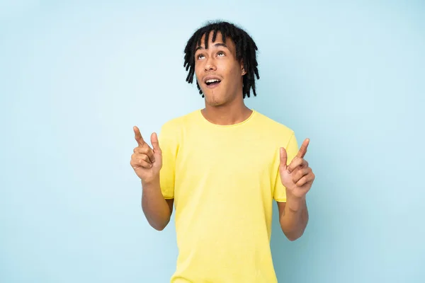 Young African American Man Isolated Blue Background Surprised Pointing — Stock Photo, Image