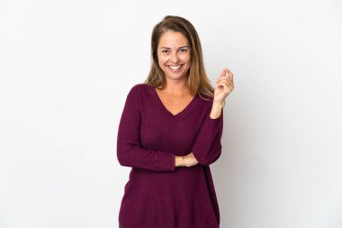 Orta yaşlı Brezilyalı bir kadın beyaz arka planda yalnız gülüyor.