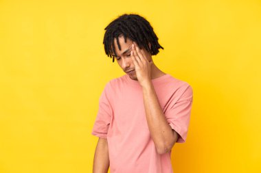 Genç Afrikalı Amerikalı adam sarı arka planda baş ağrısı ile izole edildi