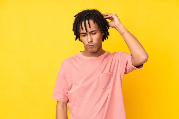 Νεαρός Αφροαμερικάνος Απομονωμένος Κίτρινο Φόντο Αμφιβολίες Ενώ Ξύνει Κεφάλι — Φωτογραφία Αρχείου