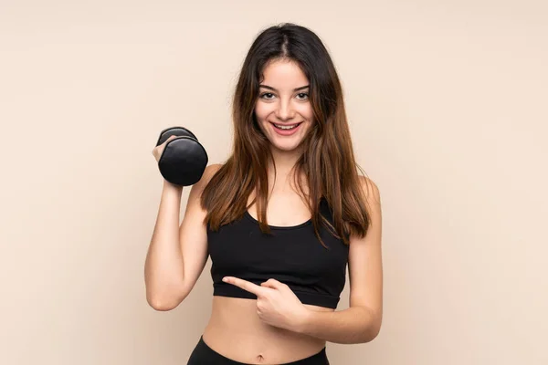Young Sport Woman Making Weightlifting Isolated Beige Background Surprised Pointing — Stock Photo, Image