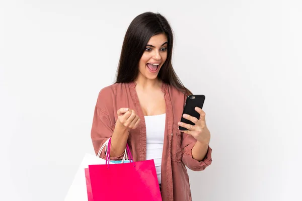 Mujer Joven Sobre Fondo Blanco Aislado Sosteniendo Bolsas Compras Escribiendo — Foto de Stock