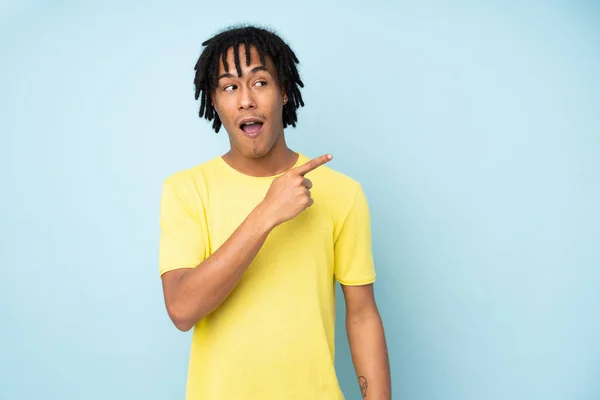 Young African American Man Isolated Blue Background Surprised Pointing Side — Stock Photo, Image