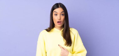 Tecrit edilmiş geçmişi olan beyaz bir kadın kendini işaret ediyor.