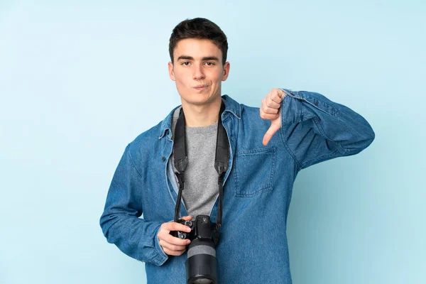 Genç Fotoğrafçı Mavi Arka Planda Izole Edilmiş Baş Parmak Aşağı — Stok fotoğraf