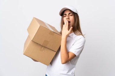 Genç teslimatçı kadın izole edilmiş beyaz arka planda esniyor ve ağzını eliyle açık tutuyor.