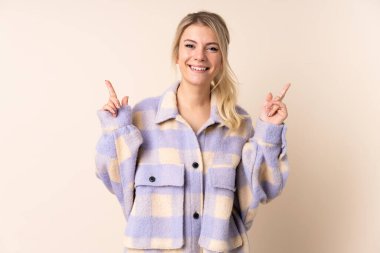 Sarışın kadın izole edilmiş arka planda harika bir fikre işaret ediyor.