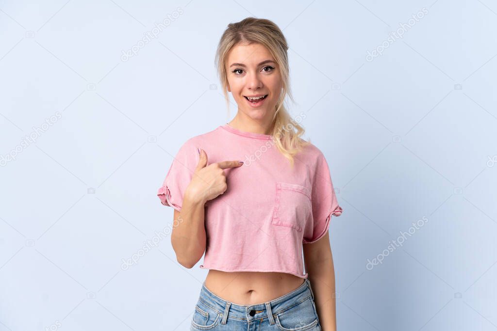 Blonde woman over isolated blue background with surprise facial expression