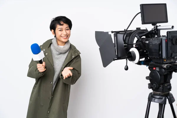 Reporter Vietnamese woman holding a microphone and reporting news applauding after presentation in a conference