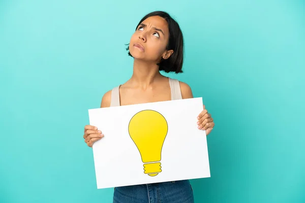 Young Mixed Race Woman Isolated Blue Background Holding Placard Bulb — Stock Photo, Image