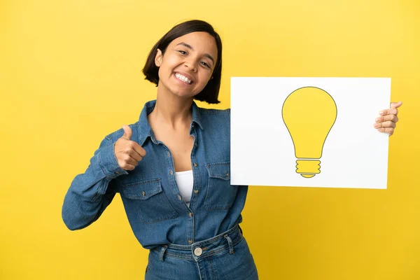 Young Mixed Race Woman Isolated Yellow Background Holding Placard Bulb — Stock Photo, Image