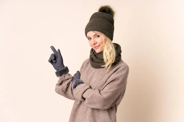 Young Woman Winter Hat Isolated Background Pointing Finger Side — Stock Photo, Image