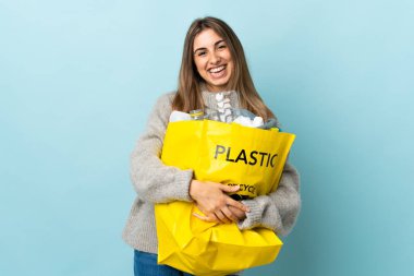 Bir torba dolusu plastik şişeyle ıssız mavi kahkahaların üzerinde geri dönüşüm yapmak için.