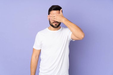 İzole edilmiş geçmişi olan beyaz, yakışıklı bir adam. Gözlerini elleriyle kapatıyor. Bir şey görmek istemiyorum.