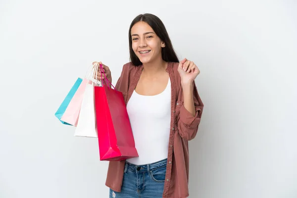 Menina Francesa Jovem Isolado Fundo Branco Segurando Sacos Compras Sorrindo — Fotografia de Stock