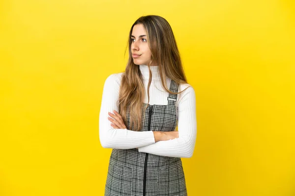 Jovem Caucasiana Isolada Sobre Fundo Amarelo Mantendo Braços Cruzados — Fotografia de Stock