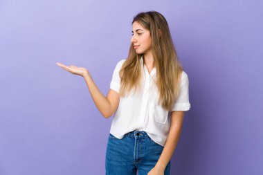 İzole edilmiş mor arka planı olan genç bir kadın telif alanını şüphelerle dolduruyor