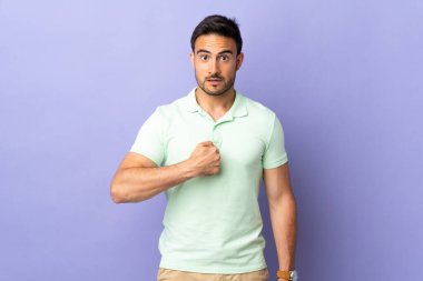 Mor arka planda soyutlanmış genç yakışıklı bir adam kendini gösteriyor.