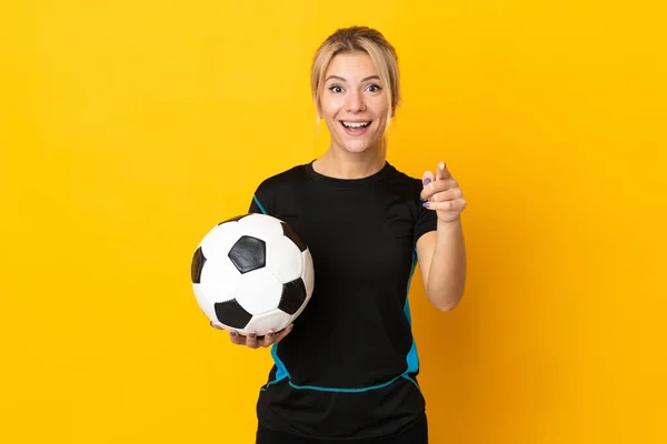 若いですロシアのサッカー選手の女性は黄色の背景に驚いて前を指す — ストック写真