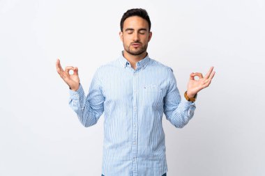 Zen pozisyonunda izole edilmiş genç yakışıklı bir adam.