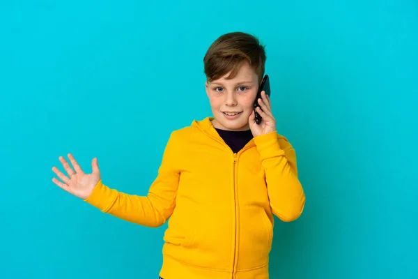 Little Redhead Boy Isolated Blue Background Keeping Conversation Mobile Phone — Stock Photo, Image