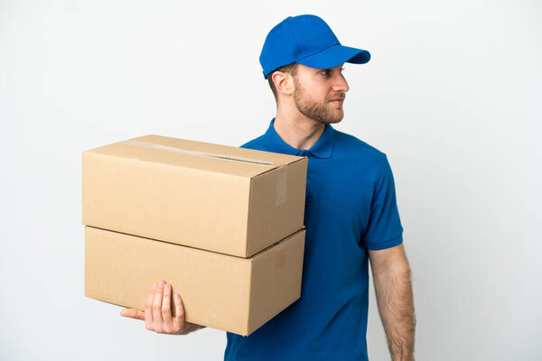 Delivery man over isolated white background looking to the side