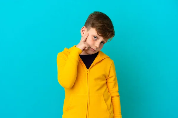 Little Redhead Boy Isolated Blue Background Thinking Idea — Stock Photo, Image