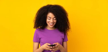 Genç Afrikalı Amerikalı kadın izole edilmiş bir geçmişi var. Cep telefonuyla mesaj gönderiyor.