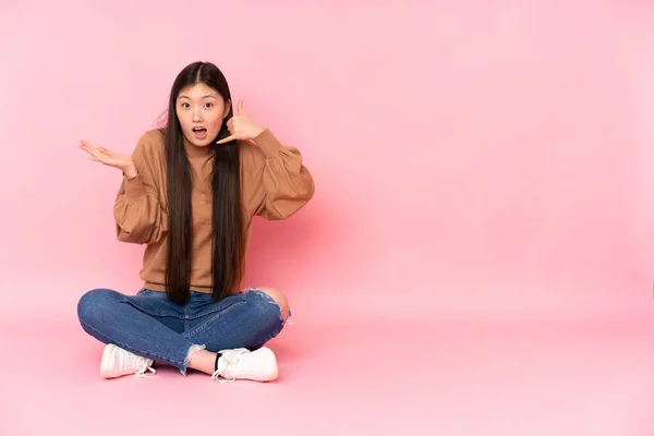 Junge Asiatische Frau Sitzt Isoliert Auf Dem Boden Auf Rosa — Stockfoto