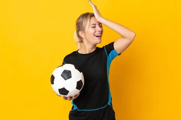 Young Russian football player woman isolated on yellow background has realized something and intending the solution