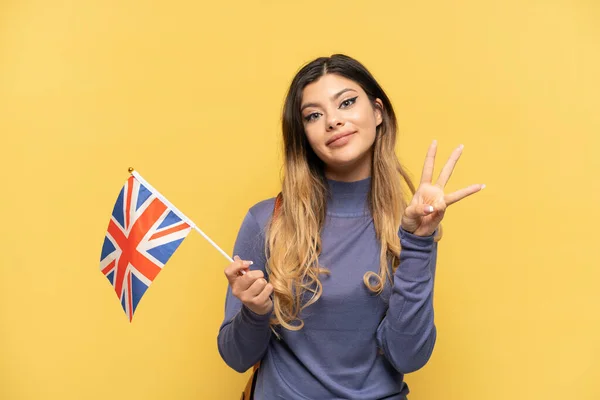 Young Russian Girl Holding United Kingdom Flag Isolated Yellow Background — Stock Photo, Image