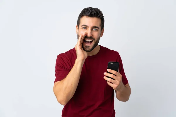 Joven Hombre Guapo Con Barba Usando Teléfono Móvil Aislado Sobre —  Fotos de Stock