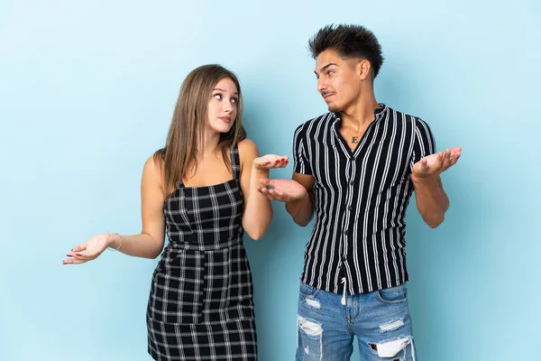 Teenager Caucasian Couple Isolated Blue Background Making Unimportant Gesture While — Stock Photo, Image