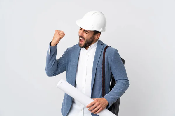 Joven Arquitecto Con Casco Planos Aislados Sobre Fondo Blanco Celebrando —  Fotos de Stock