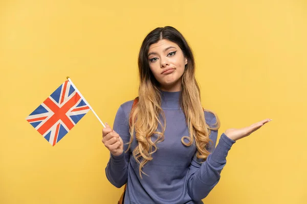 Young Russian Girl Holding United Kingdom Flag Isolated Yellow Background — Stock Photo, Image