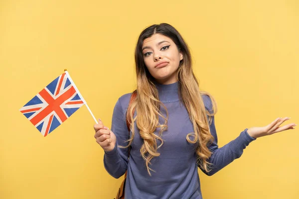 Young Russian Girl Holding United Kingdom Flag Isolated Yellow Background — Stock Photo, Image