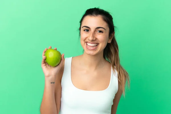 Mujer Joven Caucásica Aislada Sobre Fondo Verde Con Una Manzana — Foto de Stock