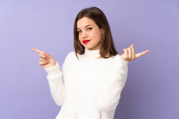 Tiener Meisje Geïsoleerd Paarse Achtergrond Wijzend Vinger Naar Lateralen Gelukkig — Stockfoto