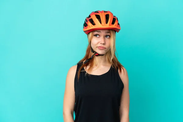 Jong Fietser Meisje Geïsoleerde Blauwe Achtergrond Maken Twijfels Gebaar Kijken — Stockfoto