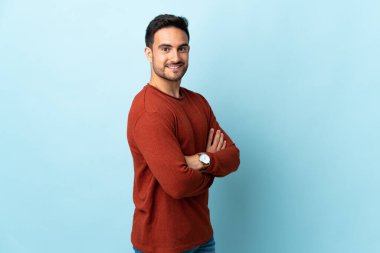 Tecrit edilmiş, kolları bağlı ve ileriye bakan genç yakışıklı bir adam.