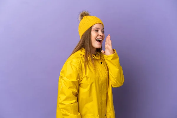 Chica Adolescente Con Abrigo Impermeable Sobre Fondo Púrpura Aislado Gritando —  Fotos de Stock