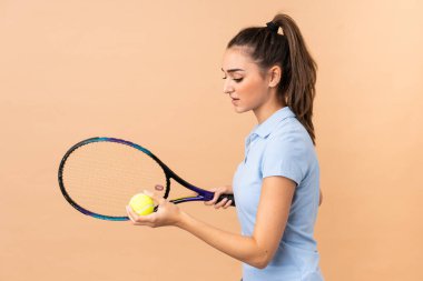 Genç bayan tenisçi izole duvarın üzerinde