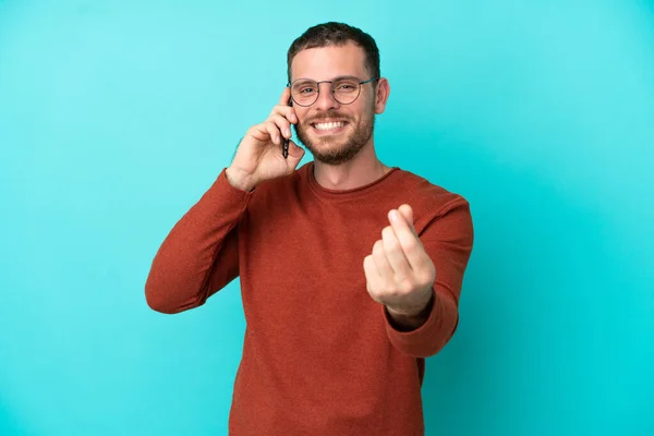 Mladý Brazilský Muž Pomocí Mobilního Telefonu Izolované Modrém Pozadí Dělat — Stock fotografie