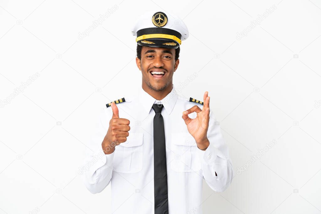 African American Airplane pilot over isolated white background showing ok sign and thumb up gesture