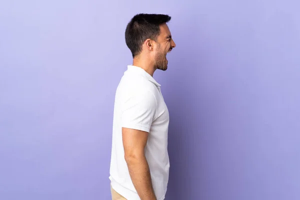 Jovem Bonito Homem Isolado Fundo Roxo Rindo Posição Lateral — Fotografia de Stock